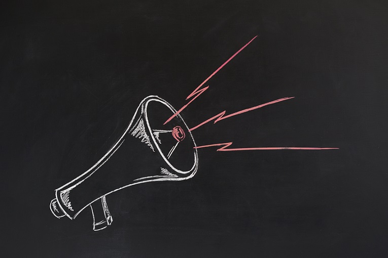 Hand drawing megaphone on the blackboard.
