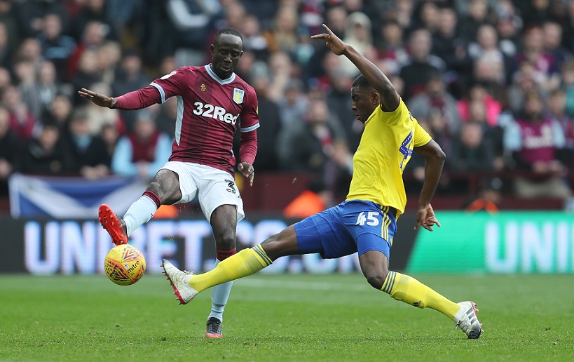 Aston Villa's Albert Adomah is tackled by Birmingham City's Wes Harding during the Sky Bet Championship match at Villa Park, Birmingham.