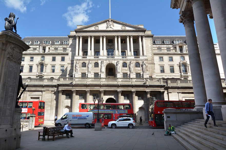 London, United Kingdom - May 13, 2015: People, cars and buses outside the Bank of England Headquarters in City of London. It's 1 of 8 banks authorised to issue banknotes in the United Kingdom, but has a monopoly on issue of banknotes in England and Wales